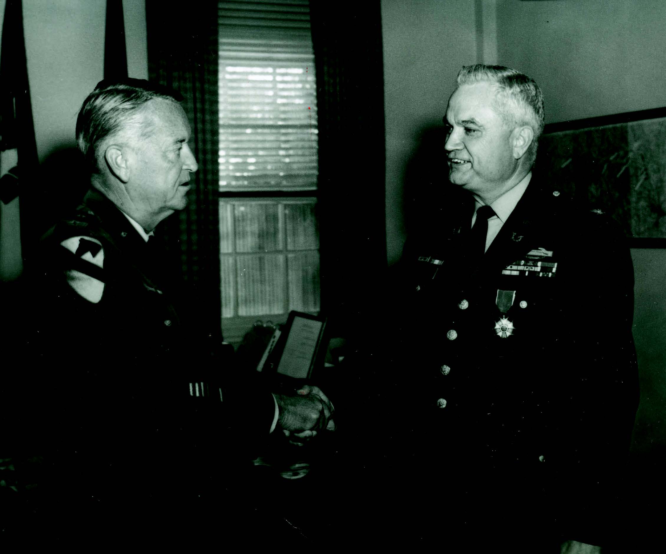 LTG John J. Tolson (left), Commanding General, XVIII Airborne Corps and Fort Bragg, congratulates COL Cecil L. Forinash (right) after presenting him with the Legion of Merit upon his retirement, 31 October 1969. (Photo courtesy of author)